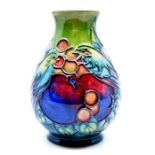 Moorcroft POttery: A Moorcroft 'Finches Green' pattern vase. Height approx 13.5cm. Impressed