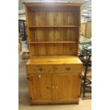 A contemporary solid pine dresser and rack, made by Hamlet, Bristol, the upper rack section fitted