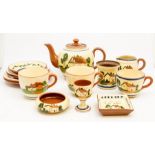 A Torquay ware terracotta part tea set comprising teapot, 3 cups and saucers, side plates, egg