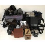 A collection of assorted cameras including Brownie, Olympus, Stylus, Sony camcorder, Ilford