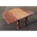 A Victorian mahogany drop leaf dining table, raised on turned and octagonal legs, 136cm long (leaves