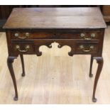 A George II oak lowboy, the top of two plank form, circa 1750, fitted with a single drawer over