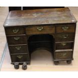 A William and Mary style oak kneehole desk, 18th Century but with alterations, comprising a