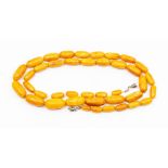 A butterscotch amber bead necklace, comprising lozenge shaped beads, largest approx 23 x 12mm,