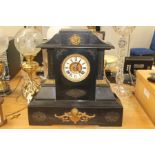 A late 19th Century American black slate mantel clock, having an eight day movement, white enamelled
