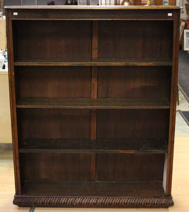 An early 20th Century oak open bookcase, fitted with three fitted shelves and a base shelf, plinth