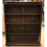 An early 20th Century oak open bookcase, fitted with three fitted shelves and a base shelf, plinth