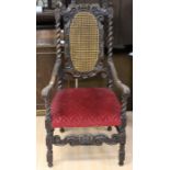 A Victorian Carolean style walnut canework back armchair, crown and scroll carved crest rail, barley