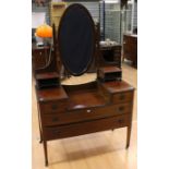 An Edwardian mahogany dressing table, mirror backed, fitted with drawers to base, measuring 169cm