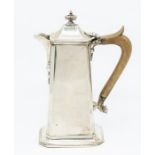 A George V silver chocolate pot, oblong tapering on raised foot, the domed cover with oblong