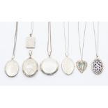 A collection of seven silver and white metal lockets, to include oval and round versions along