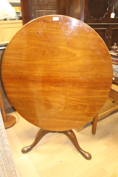 A 19th Century and later tilt top tripod table, fitted with an oval top, raised on a two part turned