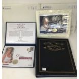 A collection of first day stamps and commemorative in binders, along with commemorative coins of