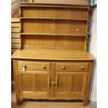 An Ercol elm dresser and rack, late 20th Century, the rack with two plate shelves, the base