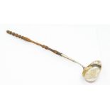 A 19th Century Swedish silver large plain oval ladle, with turned wooden handle, date letter M4