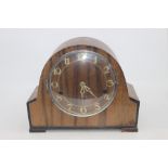 A 1950's wooden mantle clock, with Arabic numerals