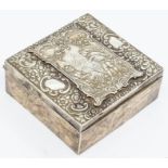 An Edwardian rectangular box and cover, the cover chased and repousse with cartouches depicting