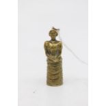 A vintage novelty brass cigar cutter cast in the form of a Lady wearing a bustle dress