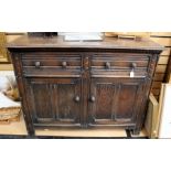 A Jacobean style oak sideboard, comprising two drawers over two doors, measuring 91cm high, 121cm