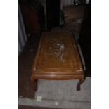 A large Chinese hardwood coffee table, inlaid to top with mother-of-pearl, measuring 50cm high,