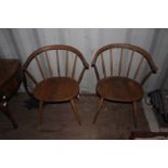 A pair of Ercol stick back chairs, 76cm high, 65cm wide, 42cm deep (2)