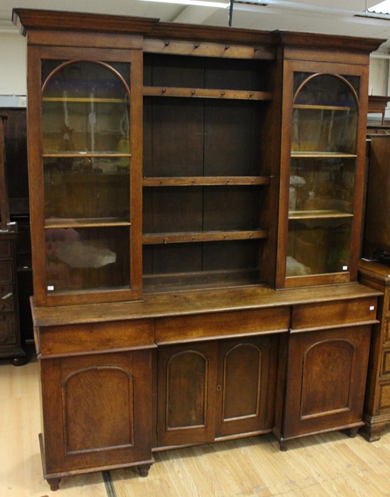 An early Victorian oak glaze topped dresser, circa 1850, the upper section with two glazed doors