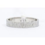 A platinum wedding band, engraved bark detail, size R, total gross weight approx 5.3gms  Condition