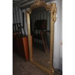 A large gilt framed wall mirror, 219cm high, 116cm wide