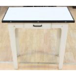 A 1950's enamelled kitchen meat table with knife drawer, white with black trim