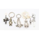 A collection of early 20th Century silver & white metal baby rattles to include:  Traditional with