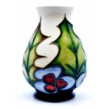 Moorcroft Pottery: A Moorcroft 'Holly' pattern vase designed by Philip Gibson. Height approx 9.