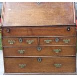 A George II oak bureau, circa 1740, the fall front enclosing a fitted interior, well section