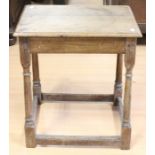 A 17th Century style joined oak side table, probably 19th Century, raised on turned supports
