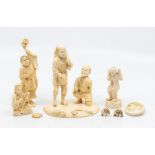 A collection of five various late 19th Century Japanese carved ivory figure to include: Man carrying