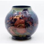 A Moorcroft Pomegranate, Grape and Bird ovoid vase, tube lined decoration on a green ground, early