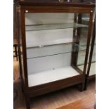 An early 20th Century mahogany display cabinet, fitted with a single glazed door, glazed sides,