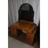 An Art Deco walnut veneered bedroom suite, comprising wardrobe, dressing table, bedside cabinet