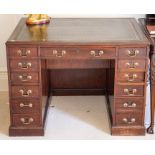 A George III and later mahogany kneehole desk, the moulded top with tooled and gilt black leather