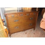 An Art Nouveau oak chest of drawers, fitted with three shallow drawers to top, with two long deep