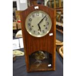 A mid 20th Century wall clock along with wood tray and two wooden figures