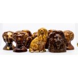 A collection of stone ware sash window stoppers in the shape of ladies and lions heads ***