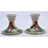 Moorcroft Pottery: A pair of Moorcroft 'Christmas Robin' pattern candle holders. Height approx 8.