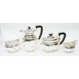 A George V silver matched four piece tea service comprising teapot, sugar bowl, milk jug and hot