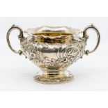 An early Victorian parcel gilt two handled sugar bowl, wavy rim above body chased and repousse