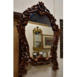 Two contemporary mirrors - one large mantle mirror and one ornately carved wooden wall mirror