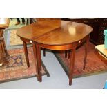 A pair of George III mahogany D ended tables, each with stringing to frieze, raised on square