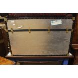 A large silver coloured travelling trunk, 62cm high, 100cm wide, 75cm deep