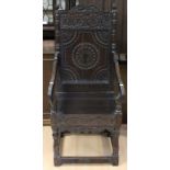 A Victorian joined oak Wainscot chair, in the 17th Century manner, having a carved crest rail,