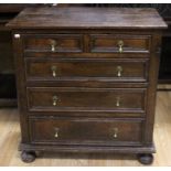 A George I joined oak chest of drawers, circa 1720, of frame and panel construction, fitted with two