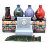 Four Poole Pottery vases in boxes, along with a Poole wall plaque of a machete and Wedgwood
